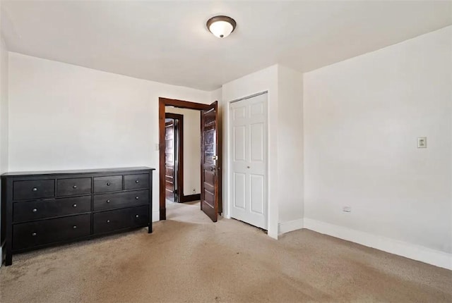 311 Jamison Ave, South Greensburg Boro, PA 15601 - unfurnished bedroom featuring baseboards, a closet, and light colored carpet