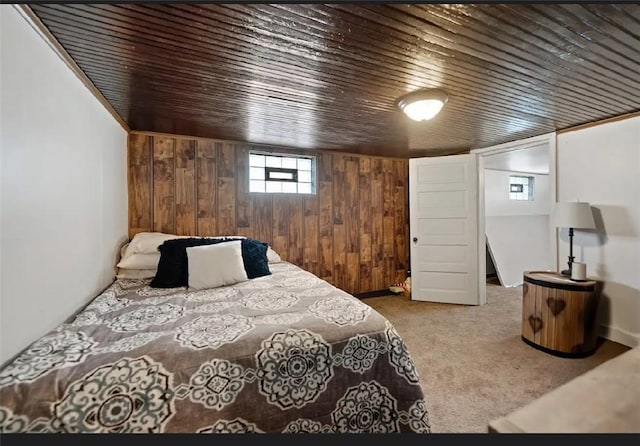 bedroom with carpet, wood ceiling, and wooden walls