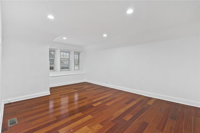 unfurnished room featuring dark hardwood / wood-style flooring