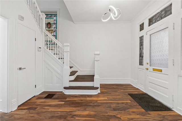 entrance foyer with crown molding and dark wood-type flooring