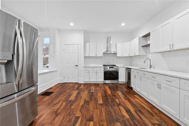 kitchen with sink, white cabinetry, stainless steel appliances, dark hardwood / wood-style flooring, and wall chimney exhaust hood