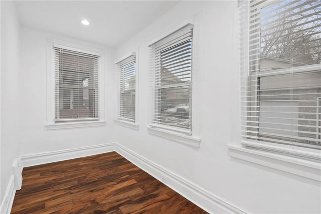 interior space featuring dark wood-style flooring, recessed lighting, and baseboards