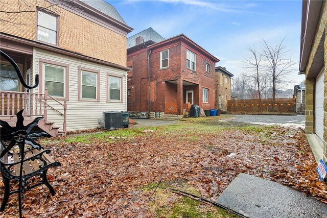 exterior space with central AC unit and fence