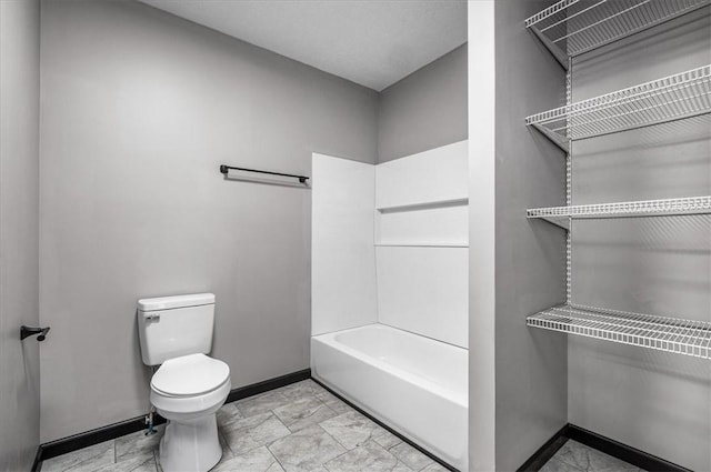 bathroom with toilet and bathing tub / shower combination