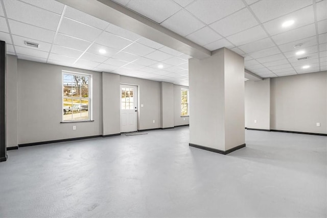 basement with a paneled ceiling