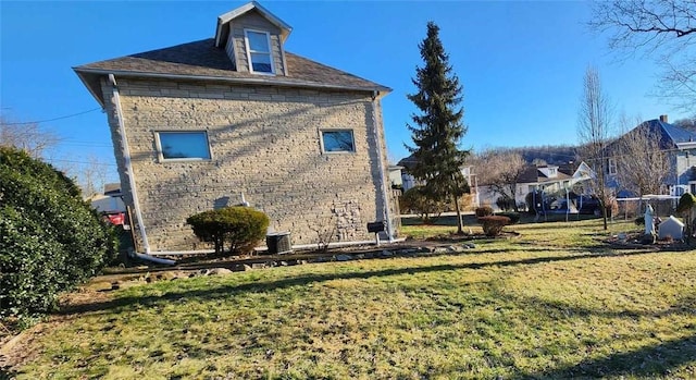 view of home's exterior featuring a lawn