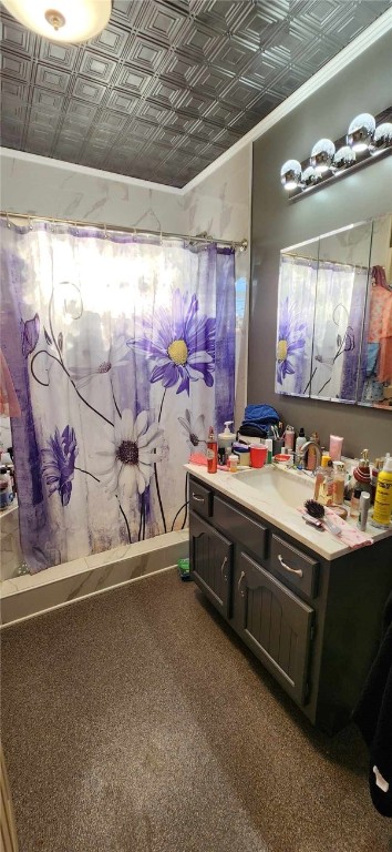 bathroom featuring vanity, ornamental molding, and walk in shower