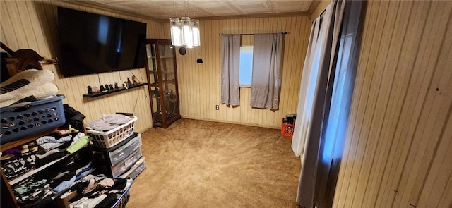 bedroom with light carpet and wooden walls