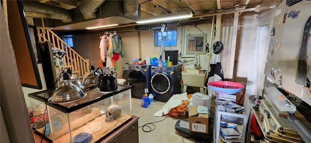 basement with sink and washing machine and clothes dryer