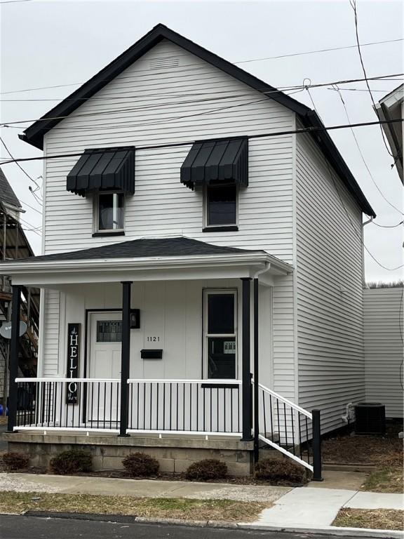 view of front of home featuring cooling unit and covered porch