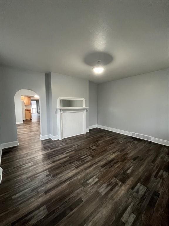 unfurnished living room featuring dark hardwood / wood-style flooring