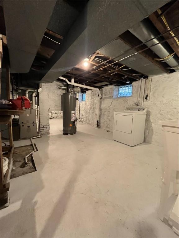basement with water heater and washing machine and dryer