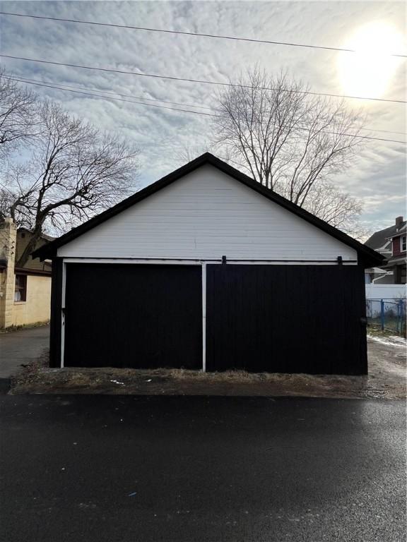 view of side of property with a garage and an outdoor structure