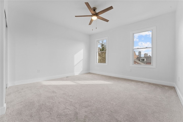 empty room with light colored carpet and ceiling fan