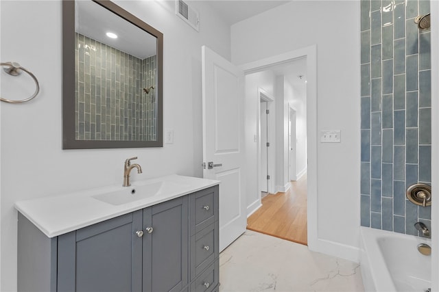 bathroom with vanity and tiled shower / bath