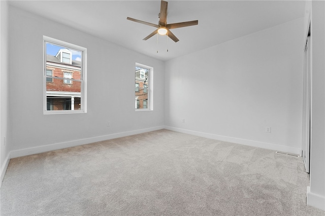 carpeted empty room featuring ceiling fan