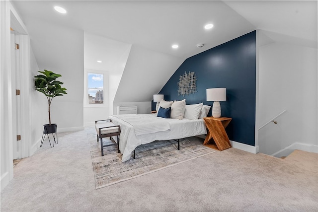 bedroom featuring light carpet and lofted ceiling