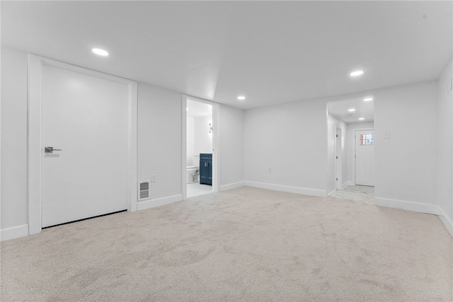 basement featuring light colored carpet