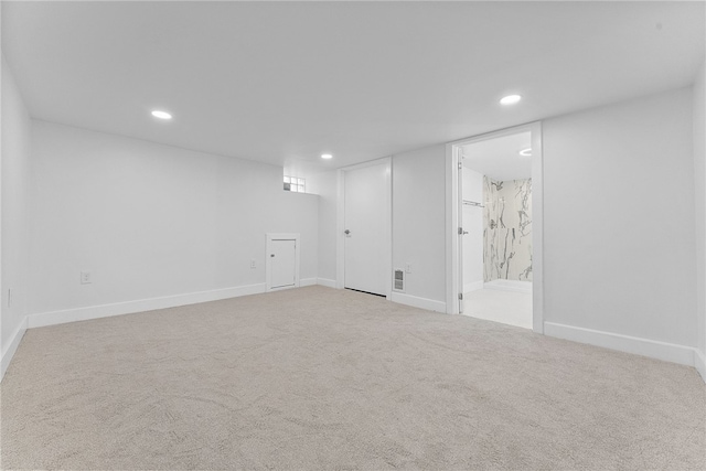 basement featuring light colored carpet