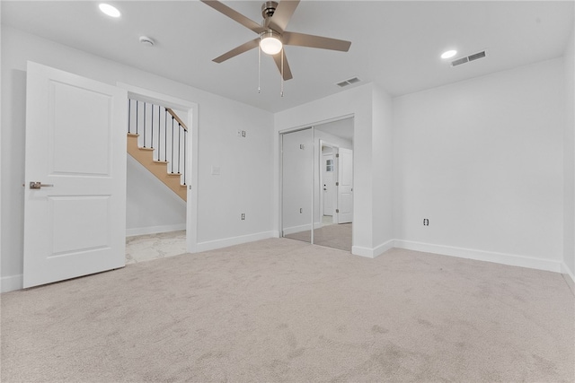 carpeted empty room featuring ceiling fan