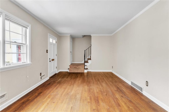 entrance foyer featuring crown molding, a baseboard radiator, and wood-type flooring