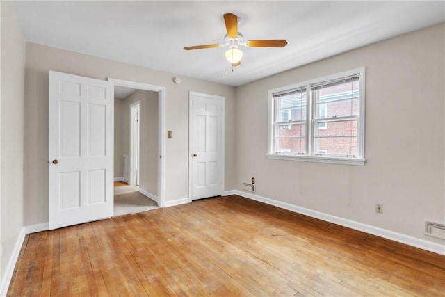 unfurnished bedroom featuring ceiling fan and light hardwood / wood-style flooring