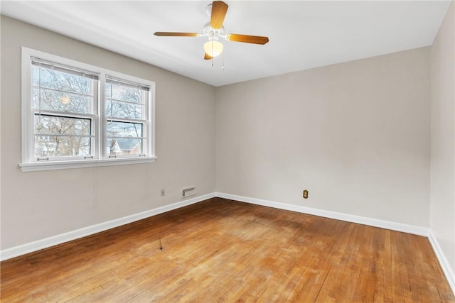 spare room featuring hardwood / wood-style floors and ceiling fan