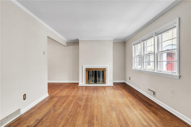 unfurnished living room featuring crown molding and light hardwood / wood-style floors