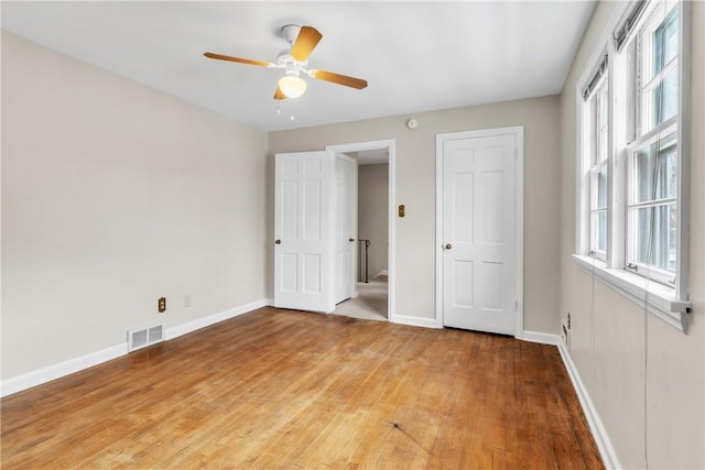 unfurnished bedroom featuring hardwood / wood-style flooring and ceiling fan