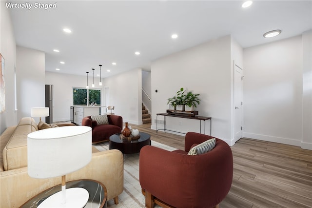 living room with sink and light hardwood / wood-style floors