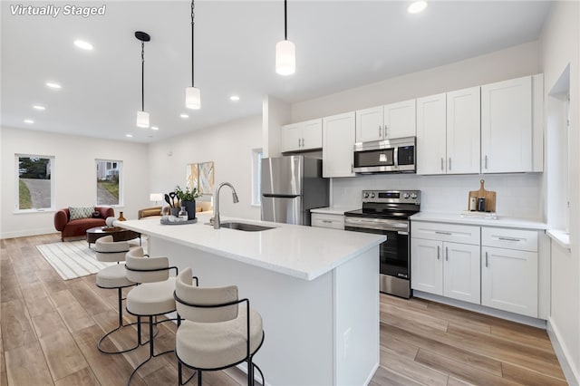 kitchen featuring white cabinetry, appliances with stainless steel finishes, and sink