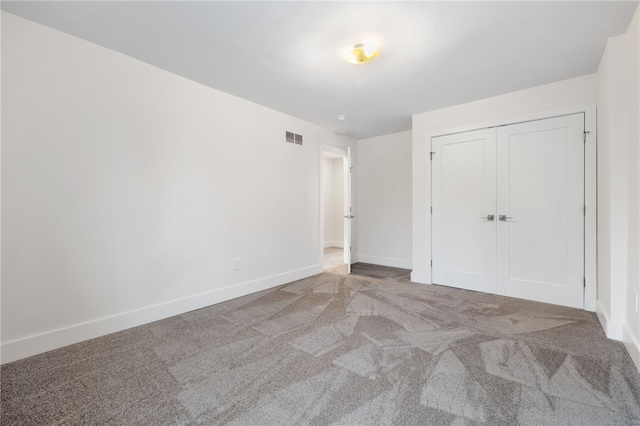 unfurnished bedroom with carpet floors and a closet