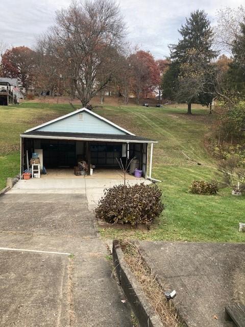 exterior space with an outbuilding, a garage, and a carport