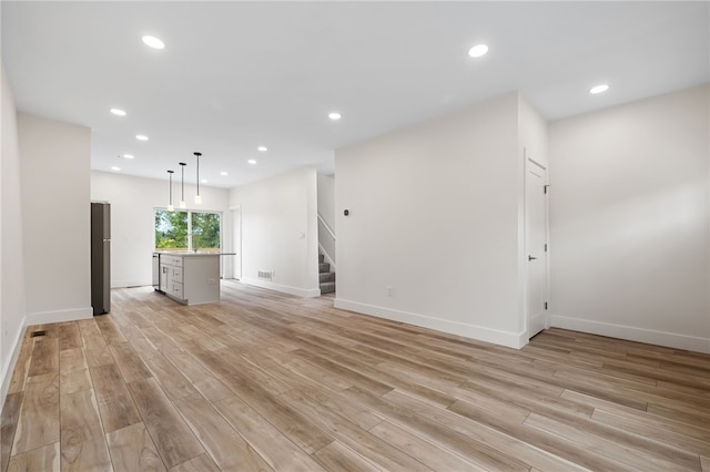unfurnished living room featuring light hardwood / wood-style flooring