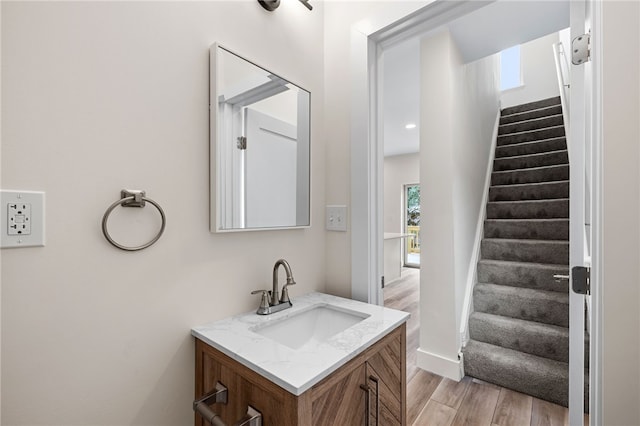 bathroom with hardwood / wood-style flooring and vanity