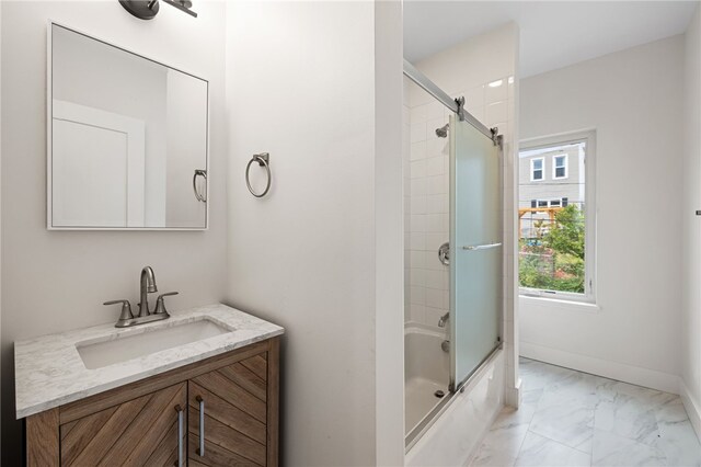 bathroom with vanity and shower / bath combination with glass door