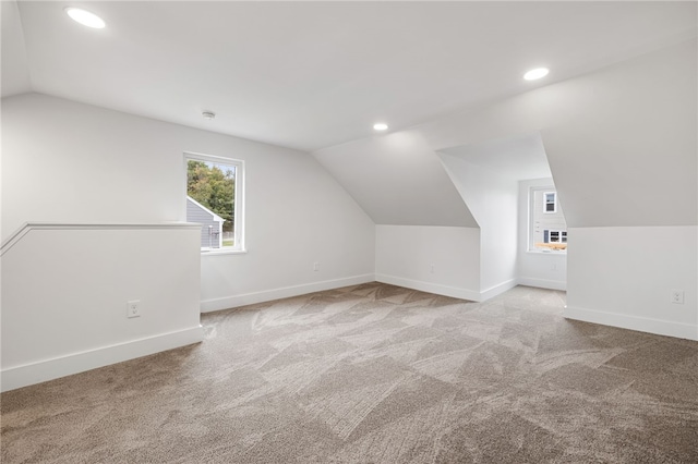bonus room featuring light carpet and vaulted ceiling