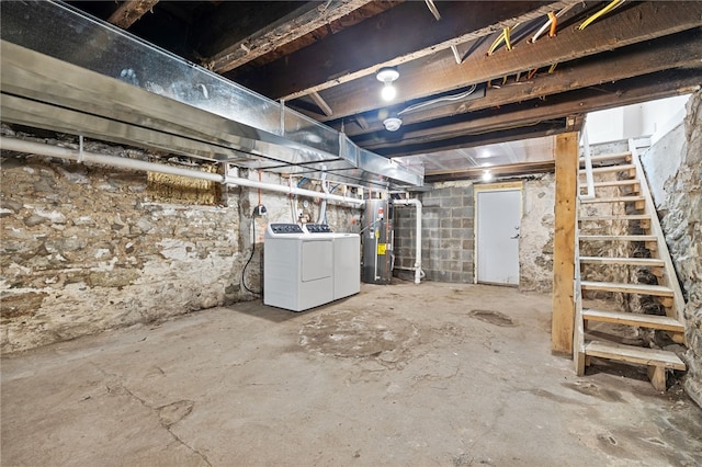 basement with water heater and washing machine and dryer
