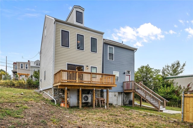 back of house featuring central AC unit, ac unit, a yard, and a deck