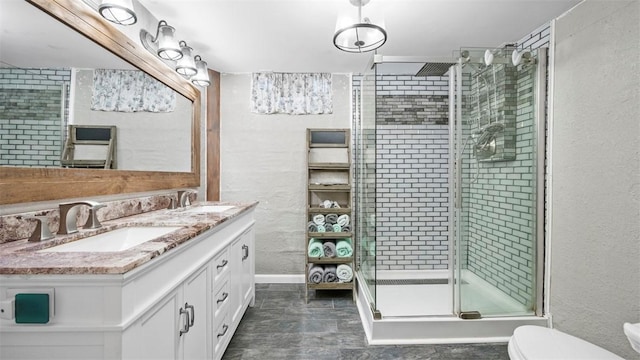 bathroom featuring vanity, toilet, and a shower with shower door