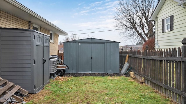 view of outdoor structure with central air condition unit and a lawn