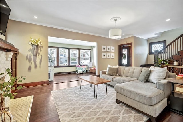 living room with ornamental molding and hardwood / wood-style floors