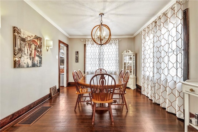 dining space featuring crown molding, a chandelier, and dark wood-type flooring