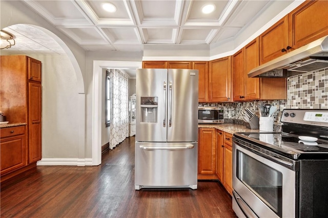 kitchen featuring coffered ceiling, extractor fan, appliances with stainless steel finishes, and dark hardwood / wood-style floors