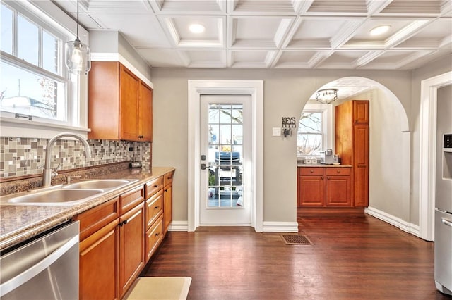 kitchen featuring dark hardwood / wood-style floors, decorative light fixtures, dishwasher, and sink