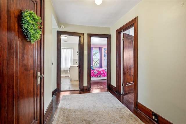 corridor with dark hardwood / wood-style floors