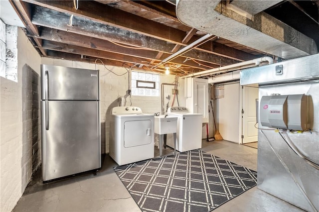 basement with separate washer and dryer and stainless steel refrigerator