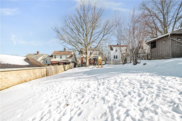 snowy yard with a playground