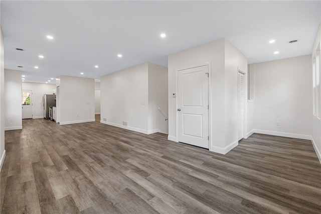 unfurnished living room with dark wood-type flooring