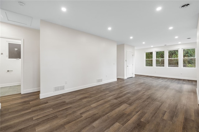 unfurnished living room with dark wood-type flooring